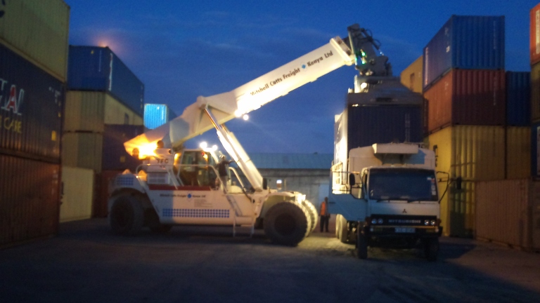 The container being loaded onto a truck